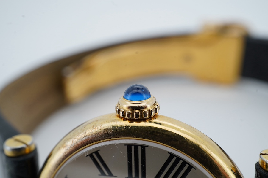 A lady's modern gilt 925 Must de Cartier quartz wrist watch, with circular Roman dial and cabochon set winding crown, case diameter 24mm, no box or papers. Condition - not running otherwise fair